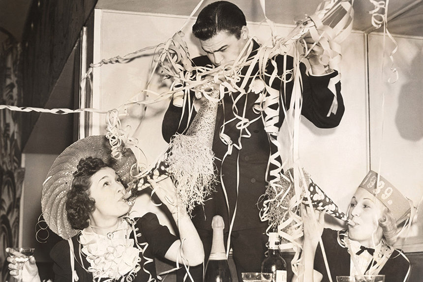 Old, vintage-style photo of revelers at a New Year's Eve parter.
