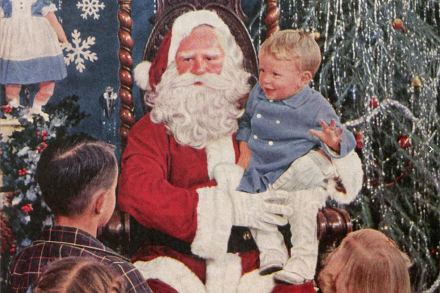 Santa Claus sitting with a small child in his lap.