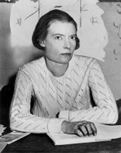 Dorothy Day at a writing desk.