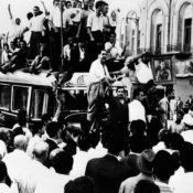 Demonstrators climb onto a bus during a Pro-Shah demonstration in 1953.