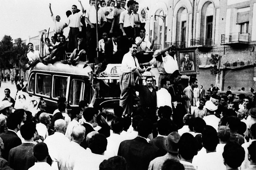 Demonstrators climb onto a bus during a Pro-Shah demonstration in 1953.