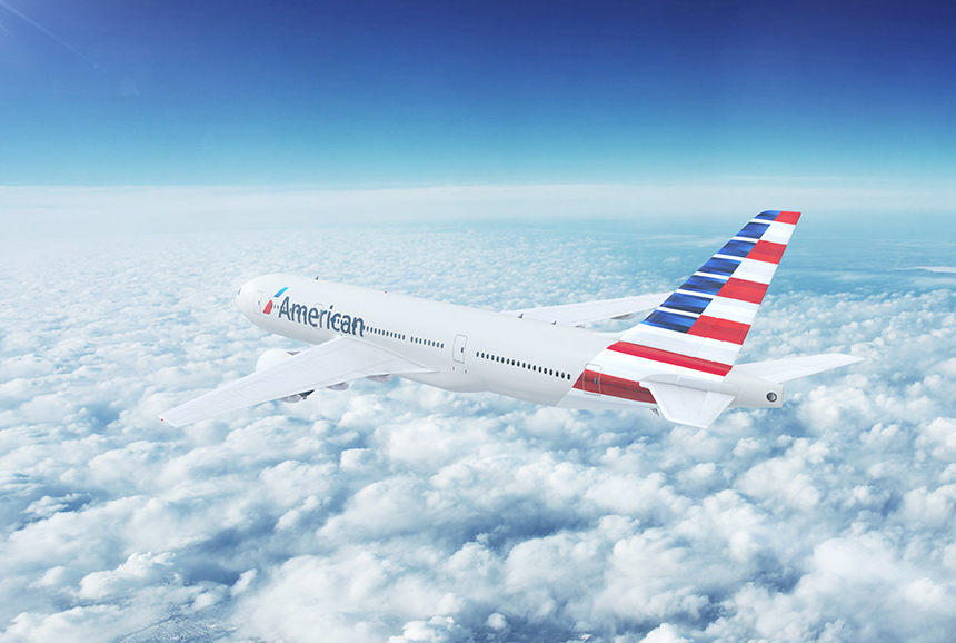 An American Airlines jetliner in flight above the clouds.