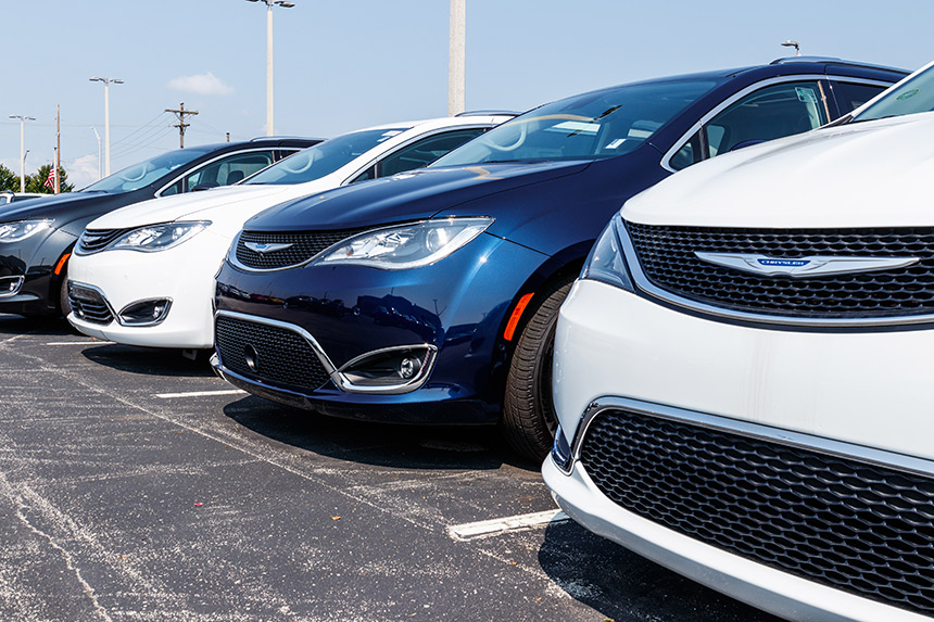 Row of cars parked at an auto dealership.