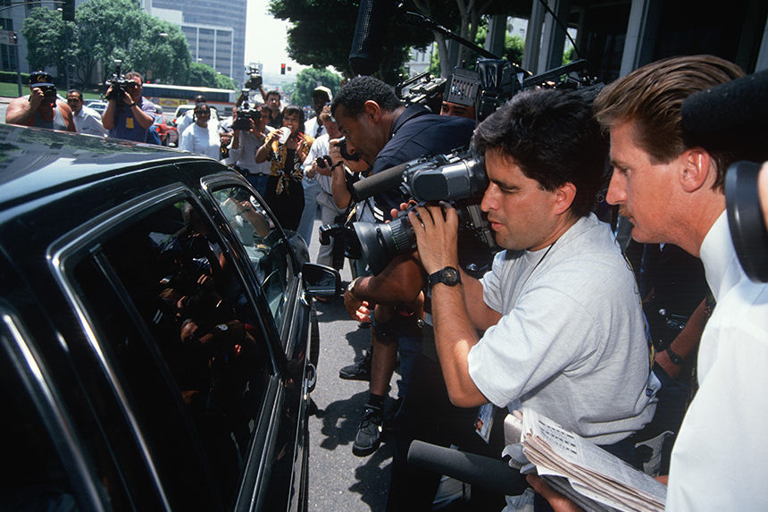Reporters swarm O.J. Simpson's motorcade during his pre-trial in 1994,