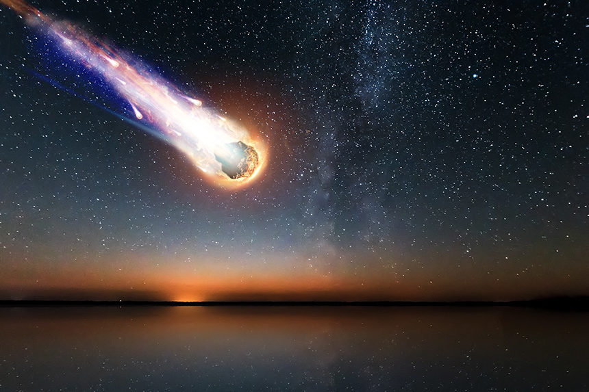 A computer-generated image of a burning meteor plummeting towards a body of water at dusk.