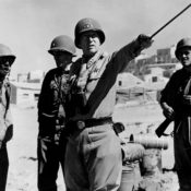 Photo of American World War II general George S. Patton, directing troops in Sicily, Italy.
