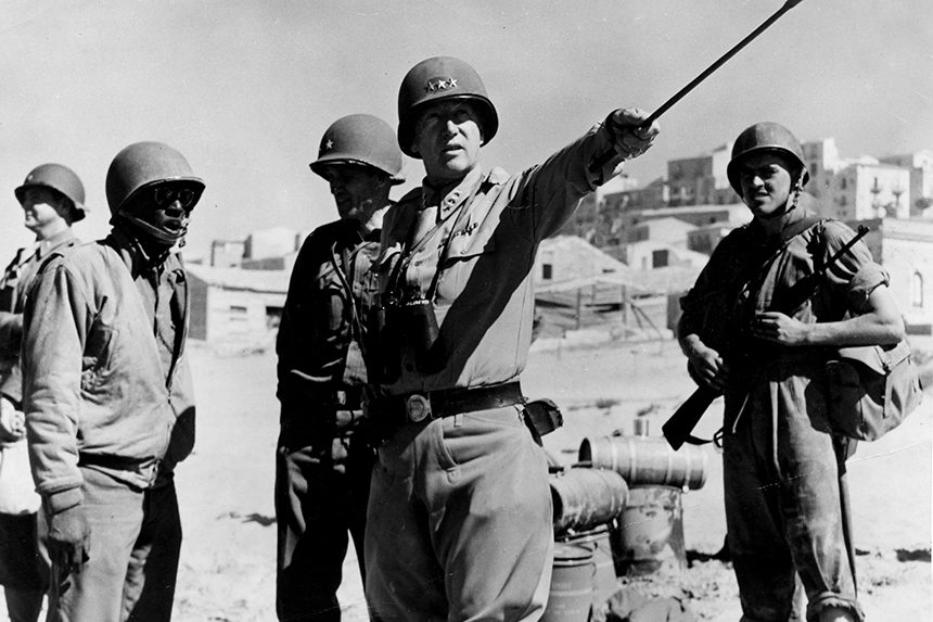 Photo of American World War II general George S. Patton, directing troops in Sicily, Italy.