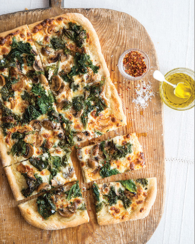 Home-made pizza on a wooden cutting board