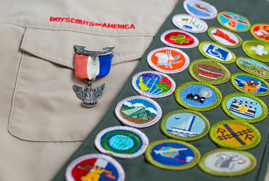 Eagle Scout merit badges on a scout sash and uniform