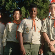 Four Boy Scouts in their uniforms posing for a photo.