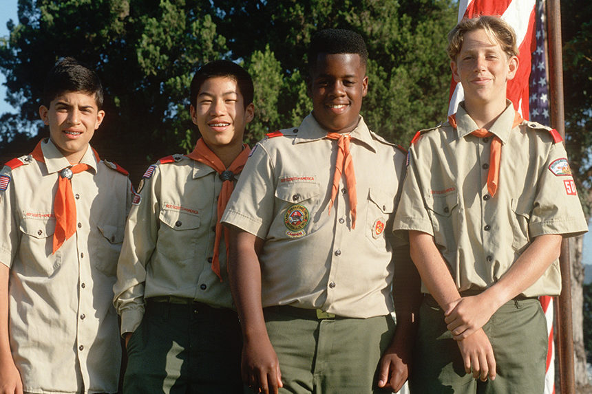 Four Boy Scouts in their uniforms posing for a photo.