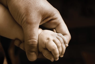 An infant's hand in a baby's hand.