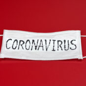Surgical face mask with the word "CORONAVIRUS" written on it