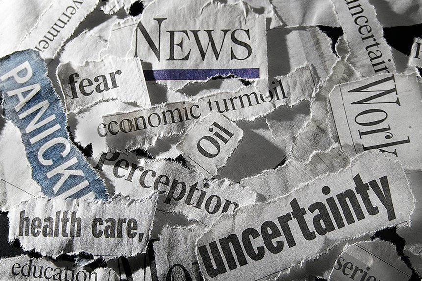 Pieces of headlines torn from newspapers, arranged in a collage
