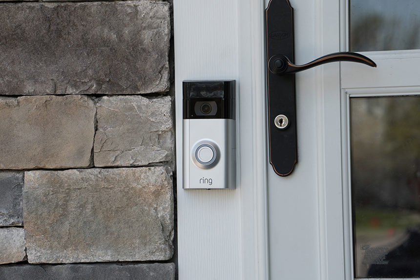A Ring home security camera installed on a home's front doorbell