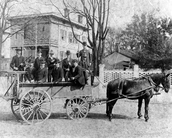 A militia filled in a horse-drawn carriage