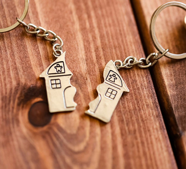A pair of keychain decorations, each representing one half of a house. Symbolizes a broken home following a divorce or a romantic breakup.