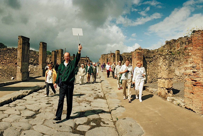 Tourists walk among the ruins of Pompeii