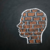 Chalk drawing of a human head full of bricks