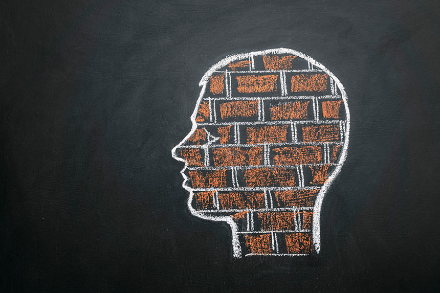 Chalk drawing of a human head full of bricks