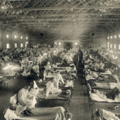 A large room full of filled hospital beds during the 1918 flu pandemic