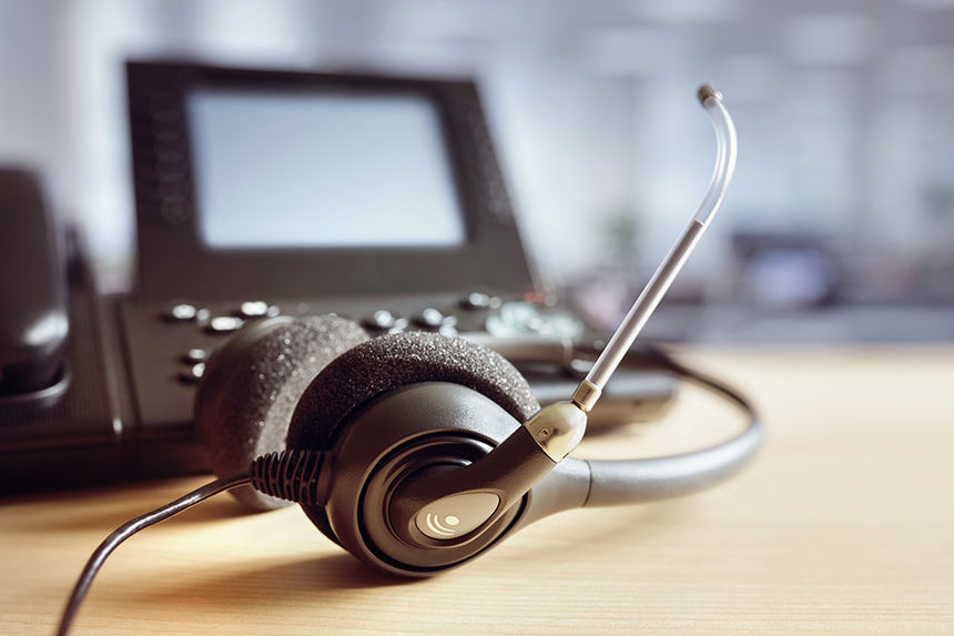Image of a headset and a telephone