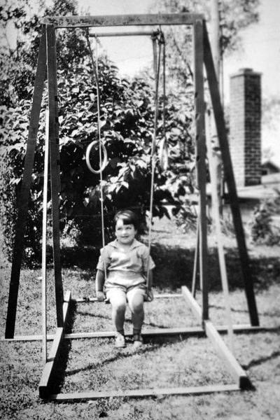 A very young Val Lauder on her a swing set at her grandparents' cottage