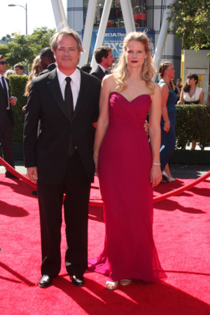 Screenwriter Graham Yost poses for a photo with Joelle Carter