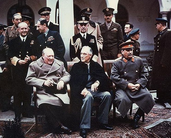 Winston Churchill, Franklin D. Roosevelt, and Josef Stalin sit at the Yalta Conference