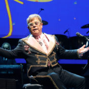 Elton John at his piano during a concert performance