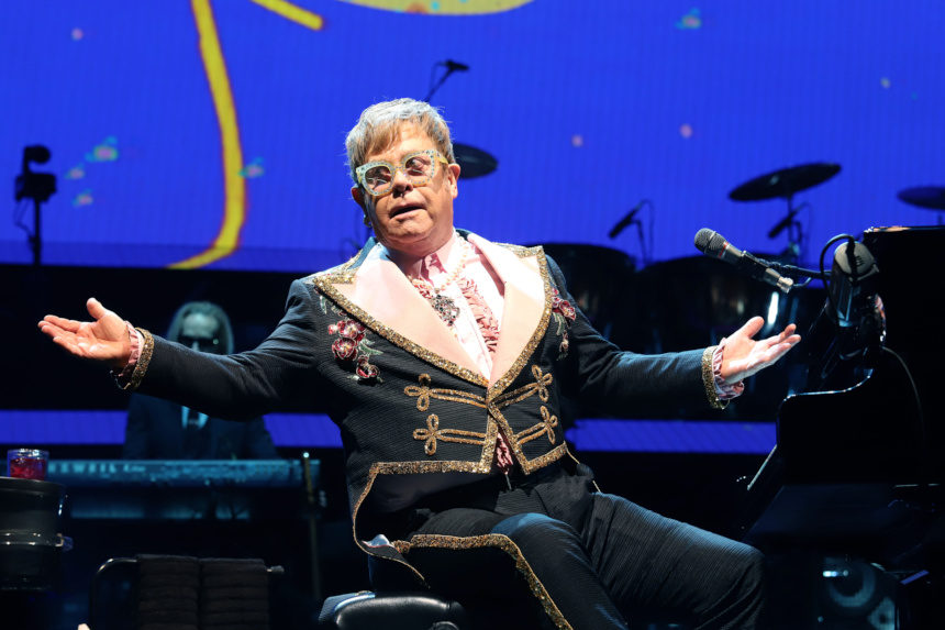 Elton John at his piano during a concert performance