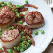 A plate of fried scallops and peas