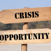 A crossroads sign with the words "crisis" and "opporunity"