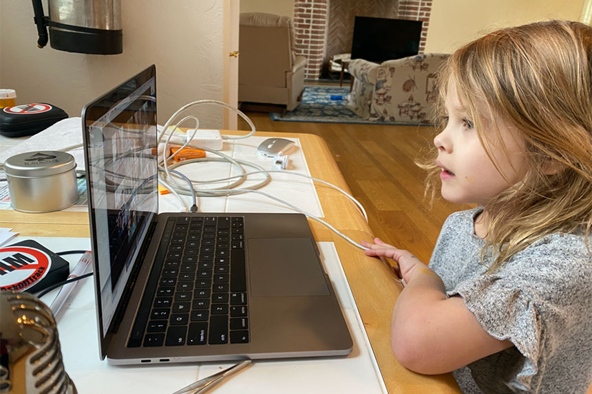 Tim Durham's daughter looks at a MacBook's screen