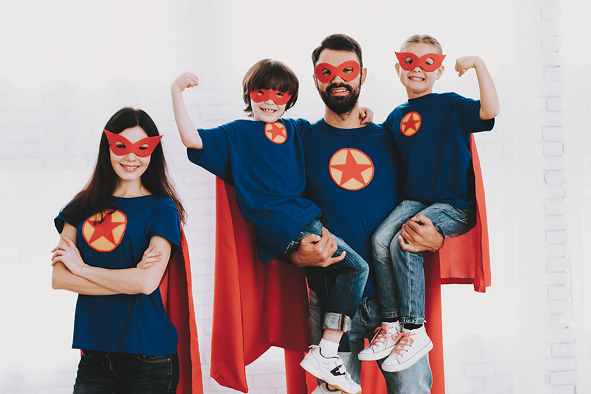 Family playing dress-up as superheroes