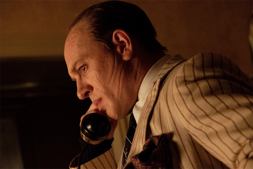 Actor Tom Hardy, as Al Capone, answers a phone in a scene from the film, "Capone"