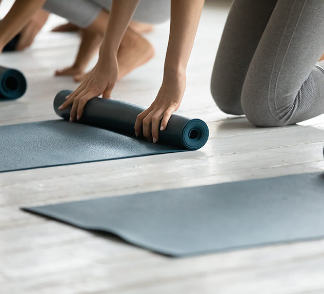 Women unrolling yoga mats