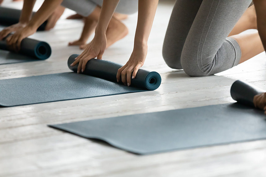 Women unrolling yoga mats