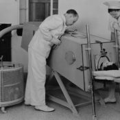 Young boy in an iron lung machine