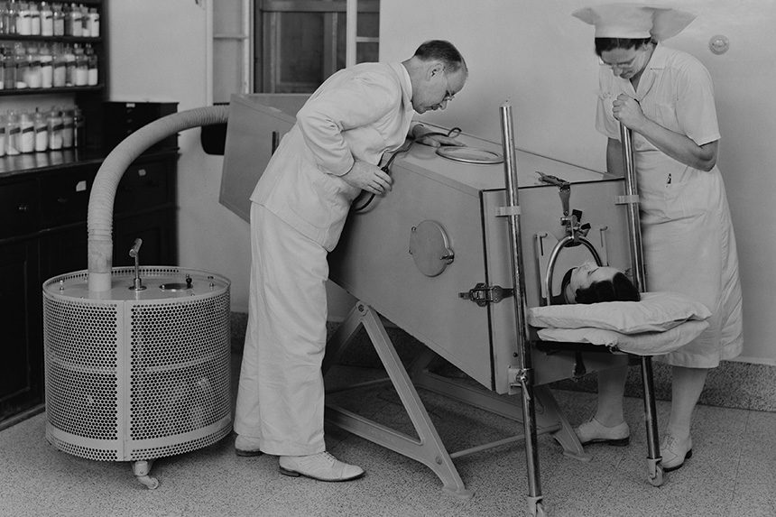Young boy in an iron lung machine