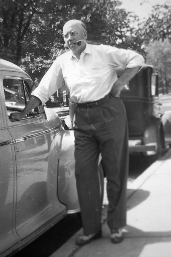 Val Lauder's dad next to a car.