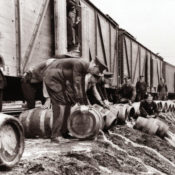 Prohibition agents break open barrels of illegal alcohol