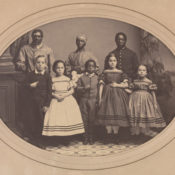 A 19th century photography of black servants and the white children in their charge.