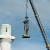 Robert E. Lee's statue is lifted off its pedestal by a crane