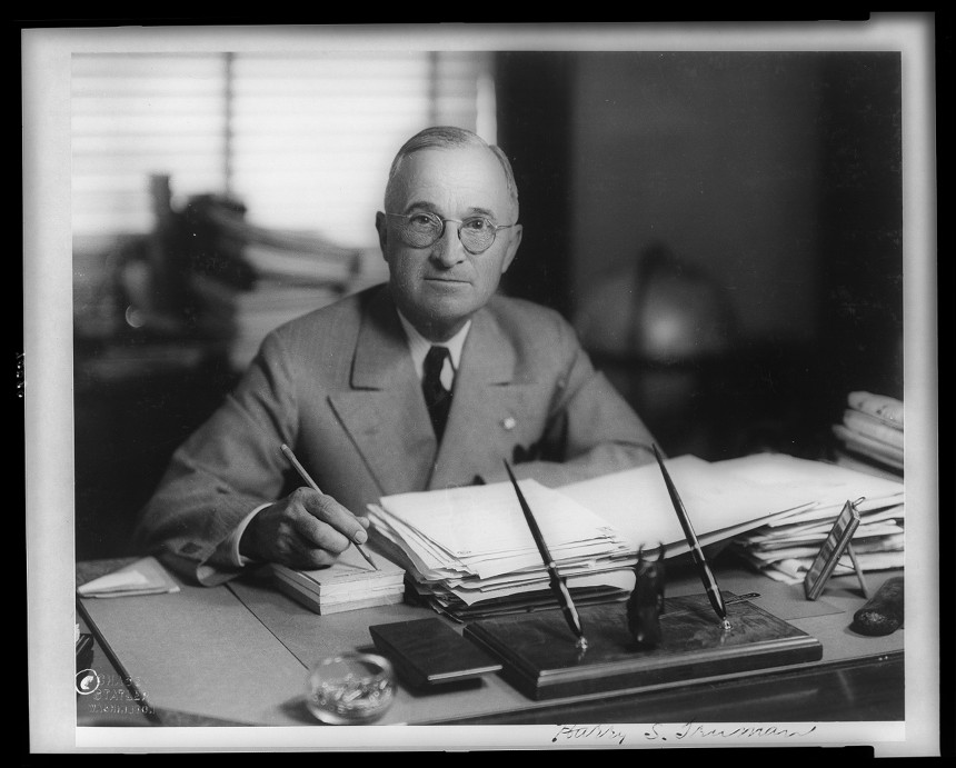 U.S. President Harry Truman at his desk in the Oval Office
