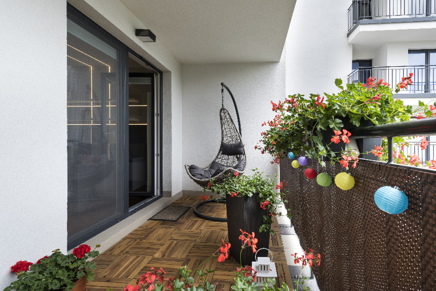 An apartment balcony with a hammock on it.