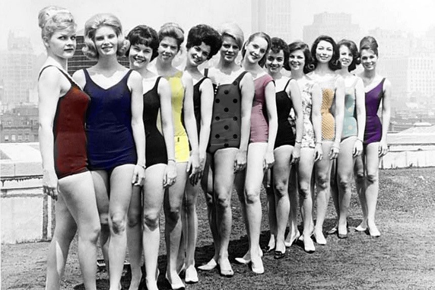 Female students of a charm school pose for a photograph in their bathing suits.