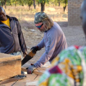 United Aid Foundation founder John Alex saws wood in a Malian villiage