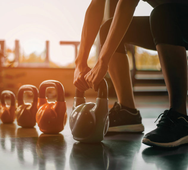 Person lifting kettlebells during a workout