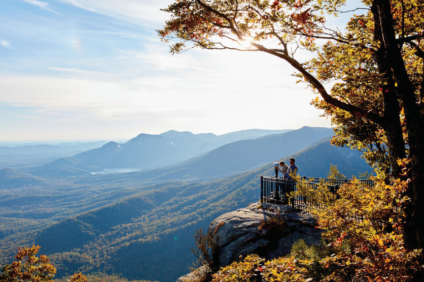 Tourists gaze out over a mountain rage in South Carolina